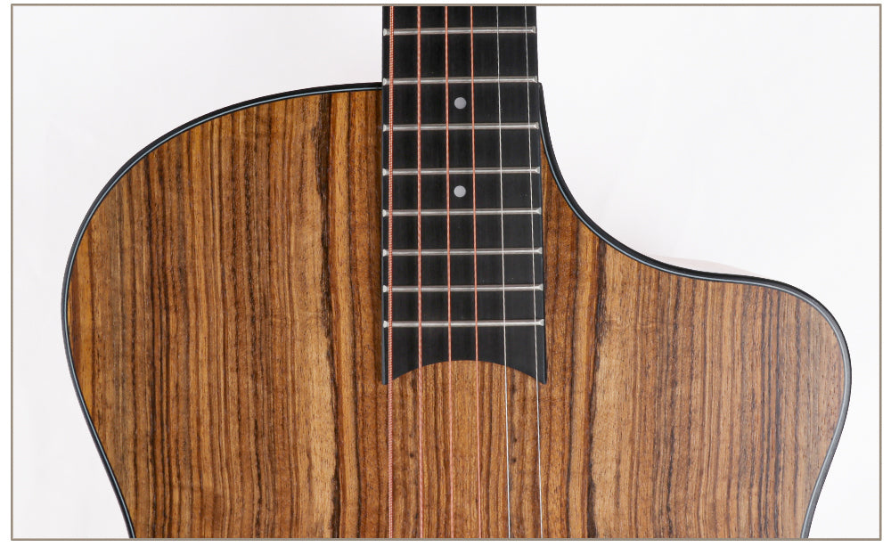 Close-up of a wooden acoustic guitar on a white background