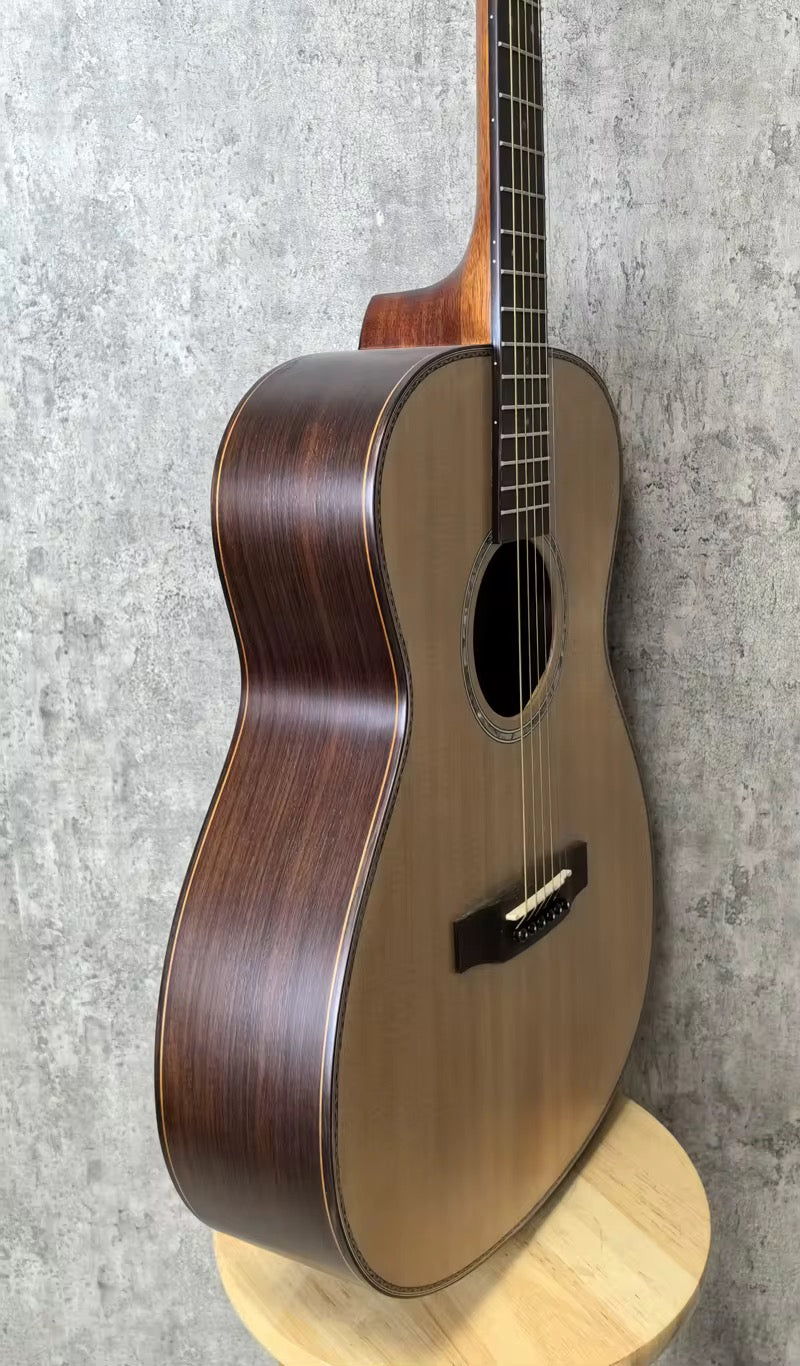 Acoustic guitar leaning against a textured gray marble backround
