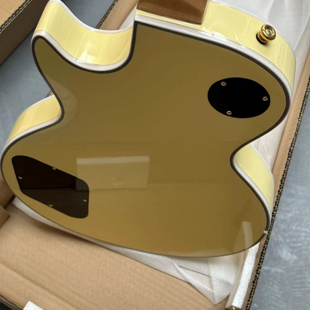 Gold guitar body on a cardboard surface, cut out from packaging, shows the brand new state of this electric guitar thats on sale in Australia.