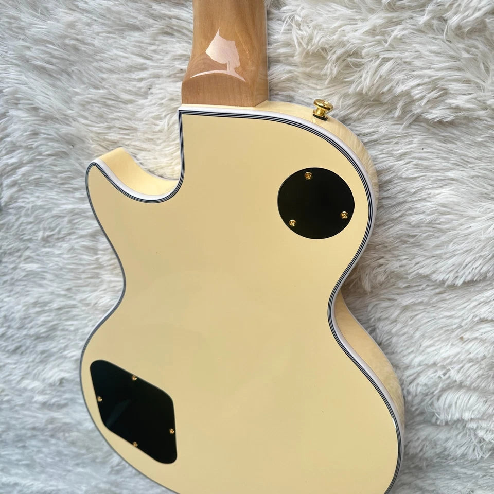 beige yellow electric guitar back view shown with the wooden fretboard on a fluffy rug.
