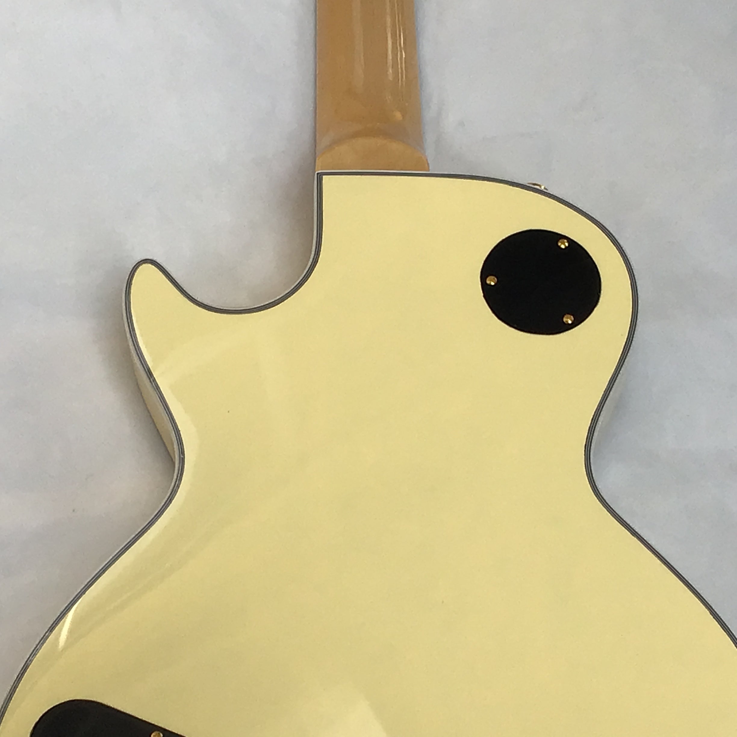Yellow electric guitar back view of the  body on a white background, perfect for metal and rock players australia.