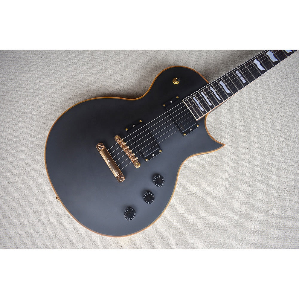 Black electric guitar on a light gray textured surface