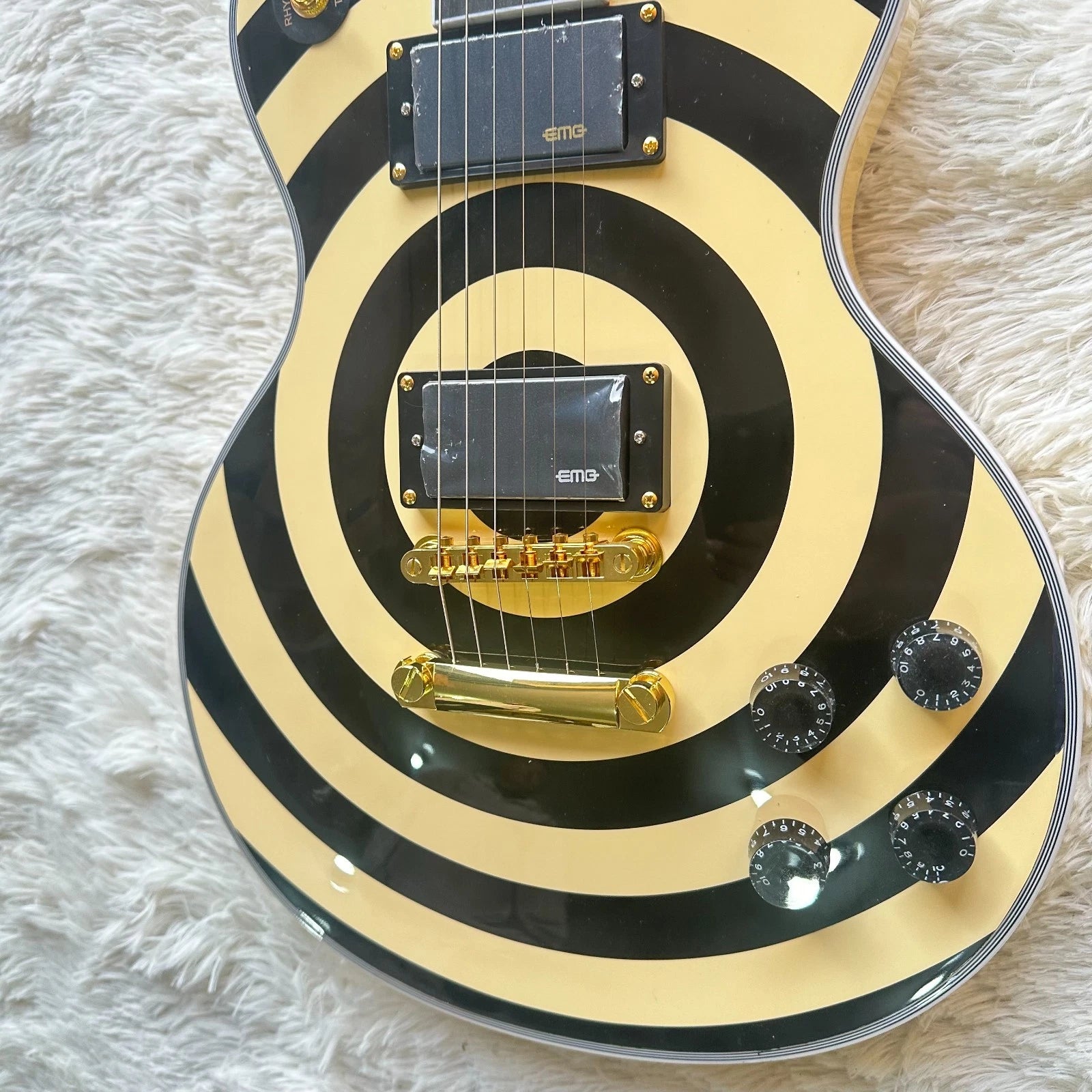 yellow black bullseye electric guitar front view australia, shown on a fluffy rug.