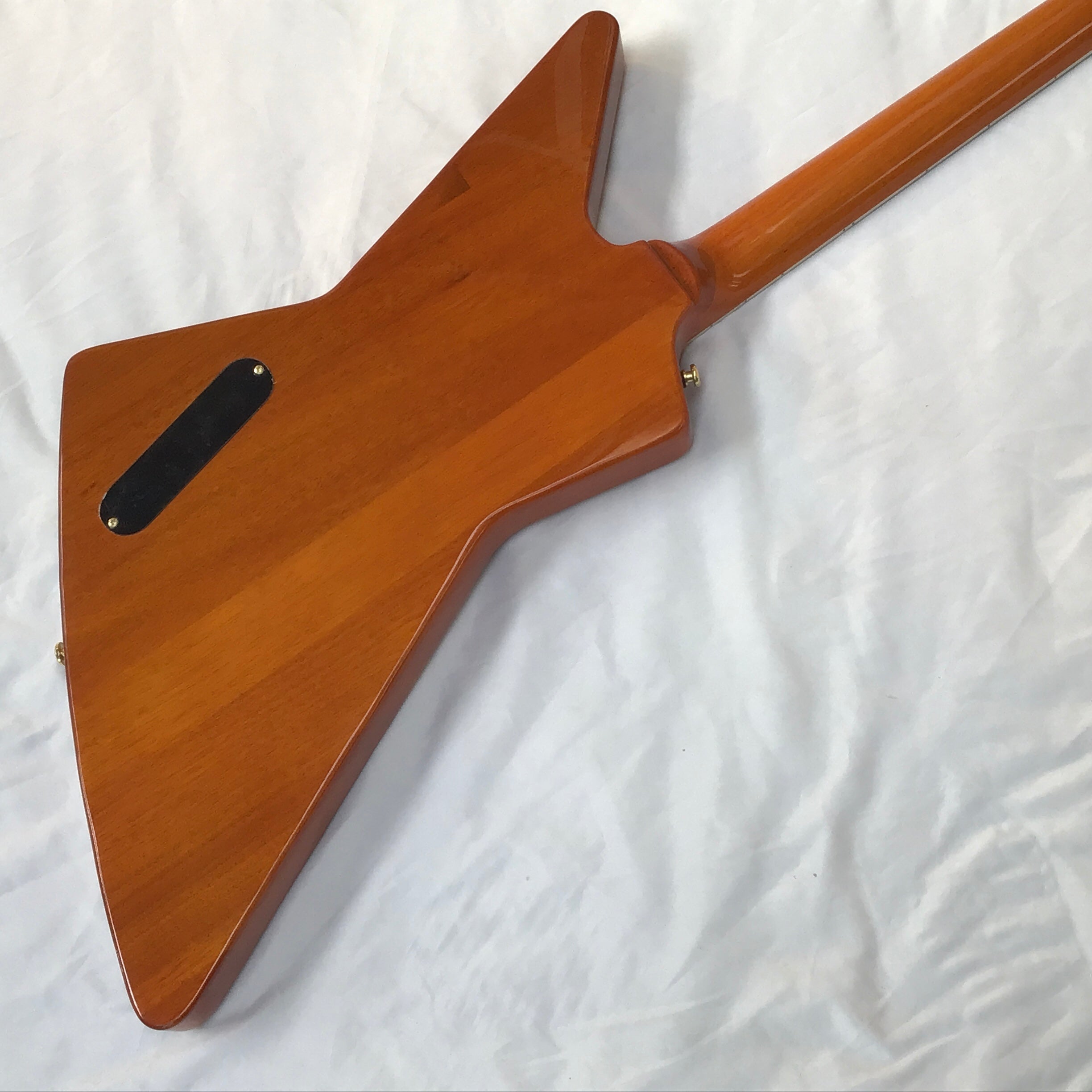 Wooden guitar body on a white background