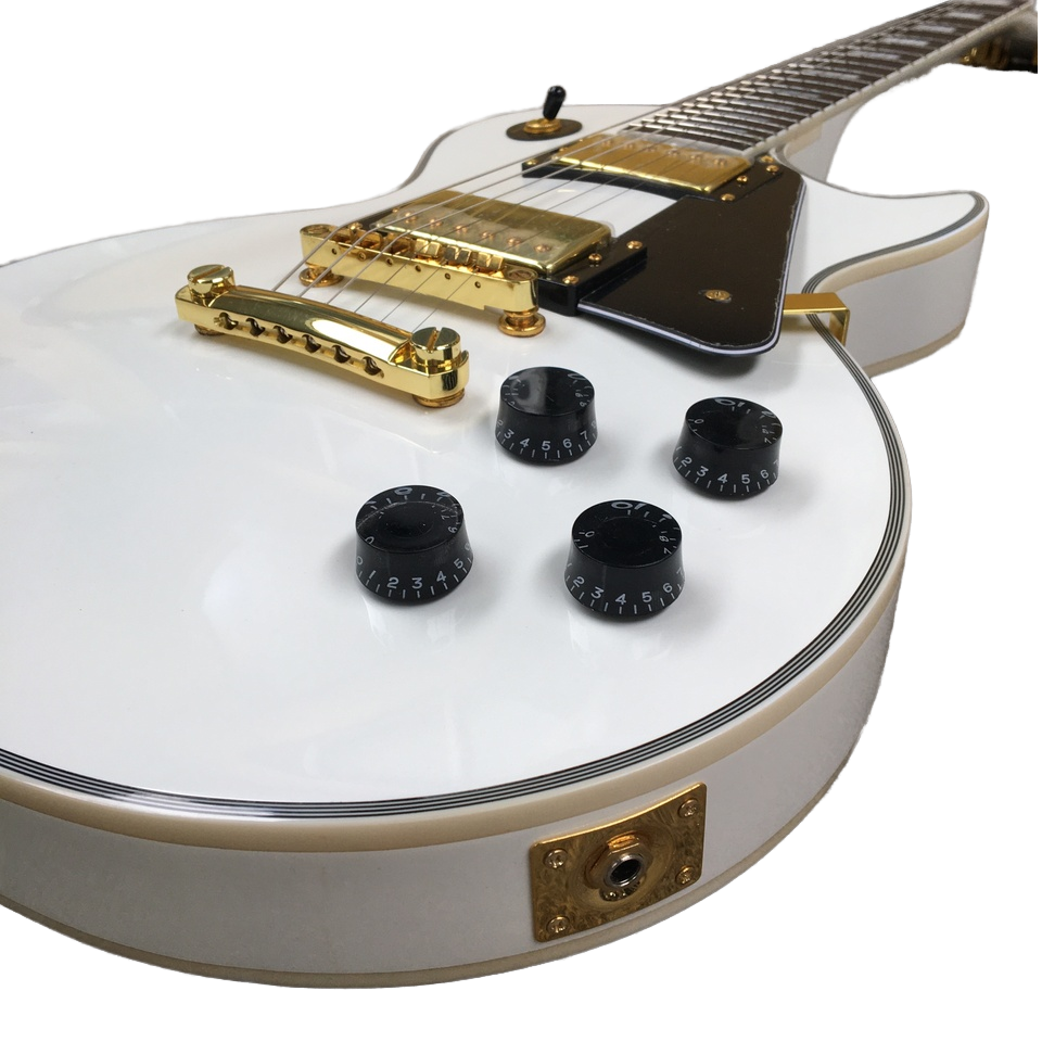 White electric guitar with gold and black details on a white background