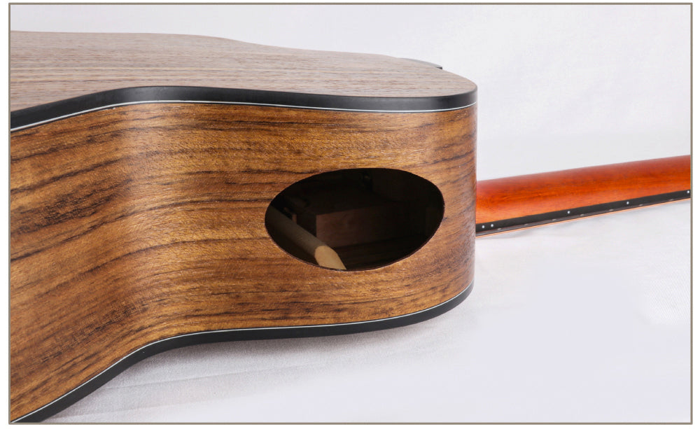 Close-up of a wooden acoustic guitar on a white background