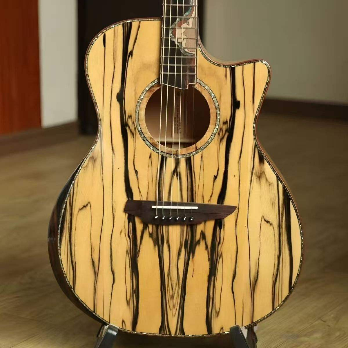 Wooden acoustic guitar with a unique grain pattern on a wooden floor. Natural wooden ginish of a luxury sandalwood guitars australia