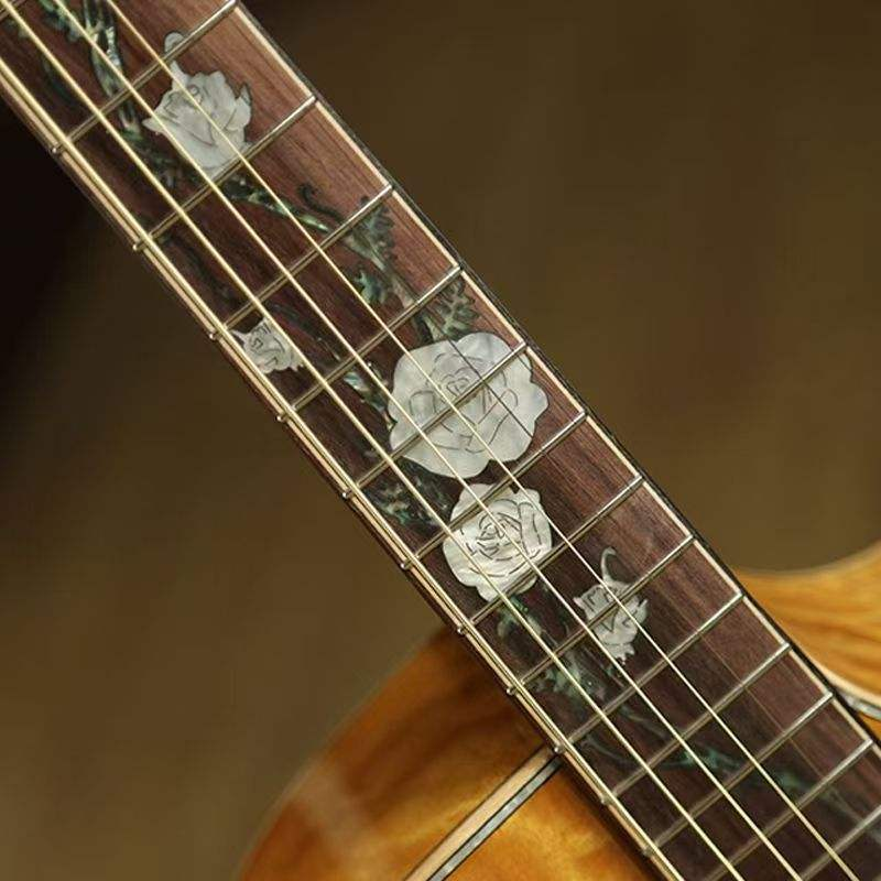 Close-up of a guitar's fretboard with decorative inlay patterns. shwos tdetailed designs of the guitars fretboard available for sale in australia.