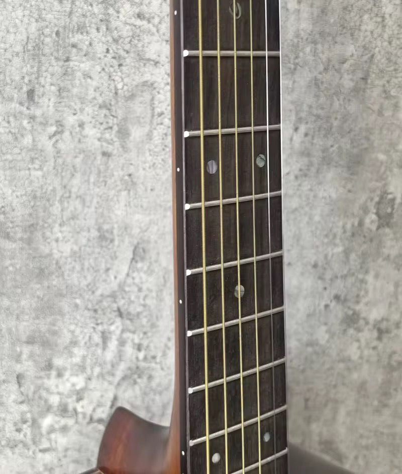 Close-up of a guitar neck against a textured gray background