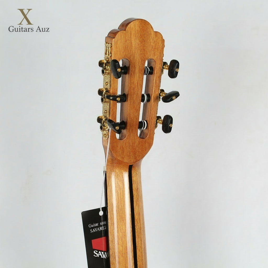 Close-up of a guitar headstock with Savarez label on a gray background
