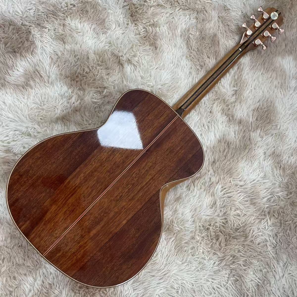 acoustic guitar back view shown on a fluffy rug