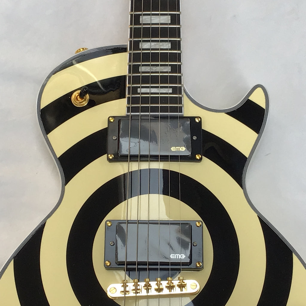 Electric guitar with black and white striped design on a gray background