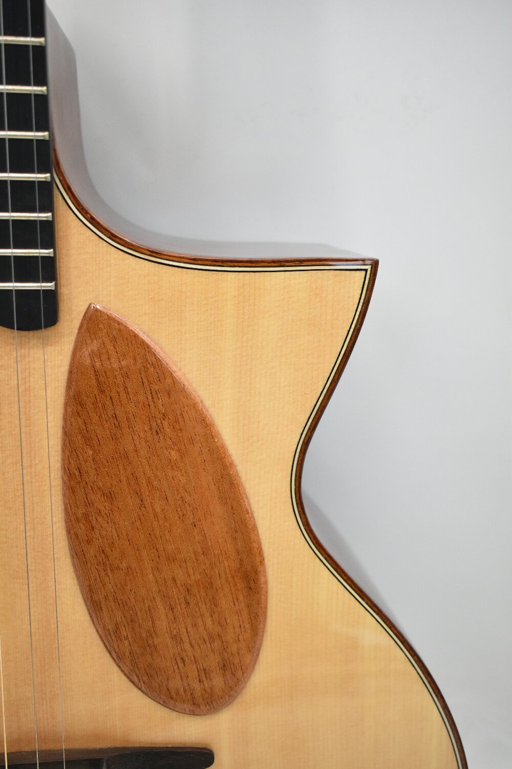 Close-up image of the guitar’s sculpted cutaway design, highlighting modern craftsmanship, smooth contours, and premium tonewood detailing. Built for Australian guitarists who want easy upper-fret access, standout aesthetics, and high-quality acoustic performance.