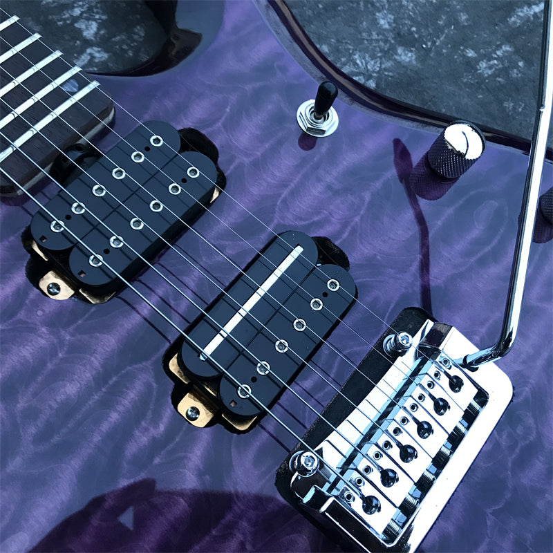 close up of purple electric guitar bridge with hsh pickups and tremolo arm.
