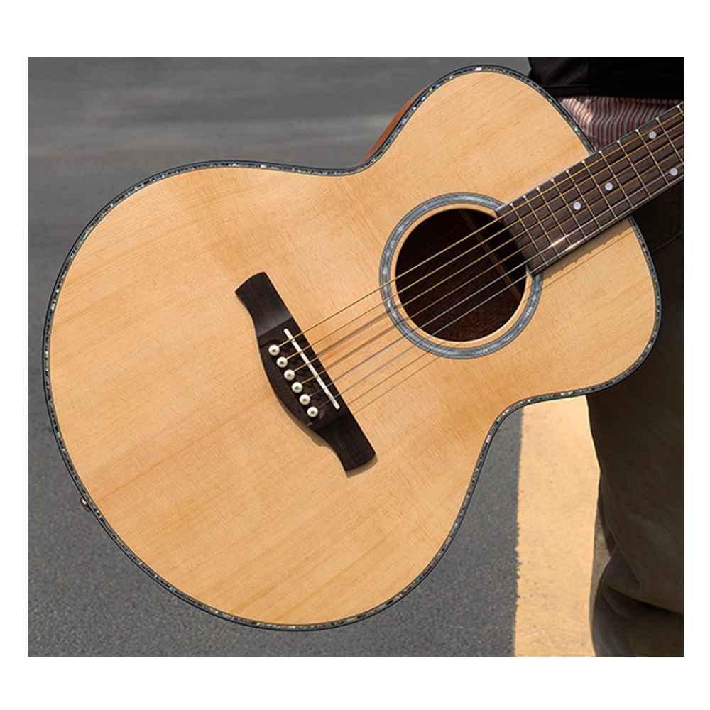 Close-up of a wooden acoustic guitar on a gray background