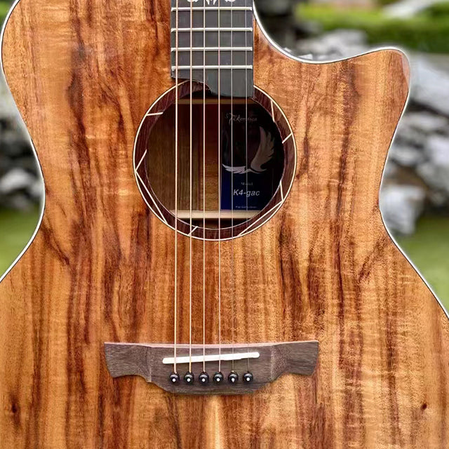 Close-up of a wooden acoustic guitar with a blurred outdoor background