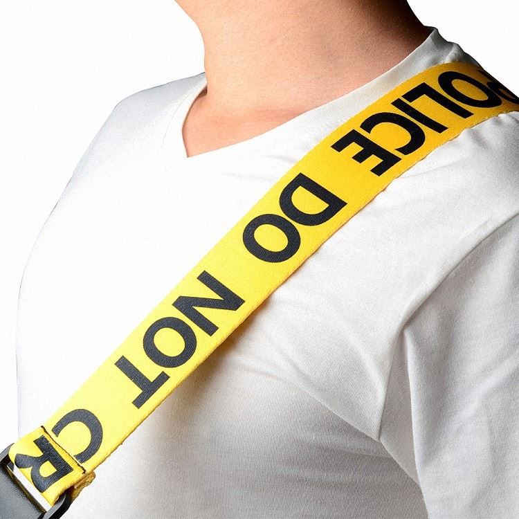 Yellow “POLICE LINE” guitar strap on shoulder — adjustable acoustic, electric, and bass guitar strap available in Sydney Australia.